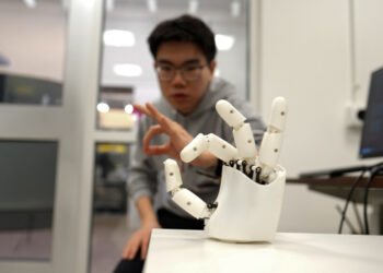 Wristband enables wearers to control a robotic hand.