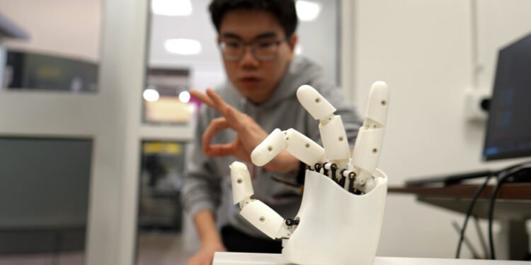 Wristband enables wearers to control a robotic hand.